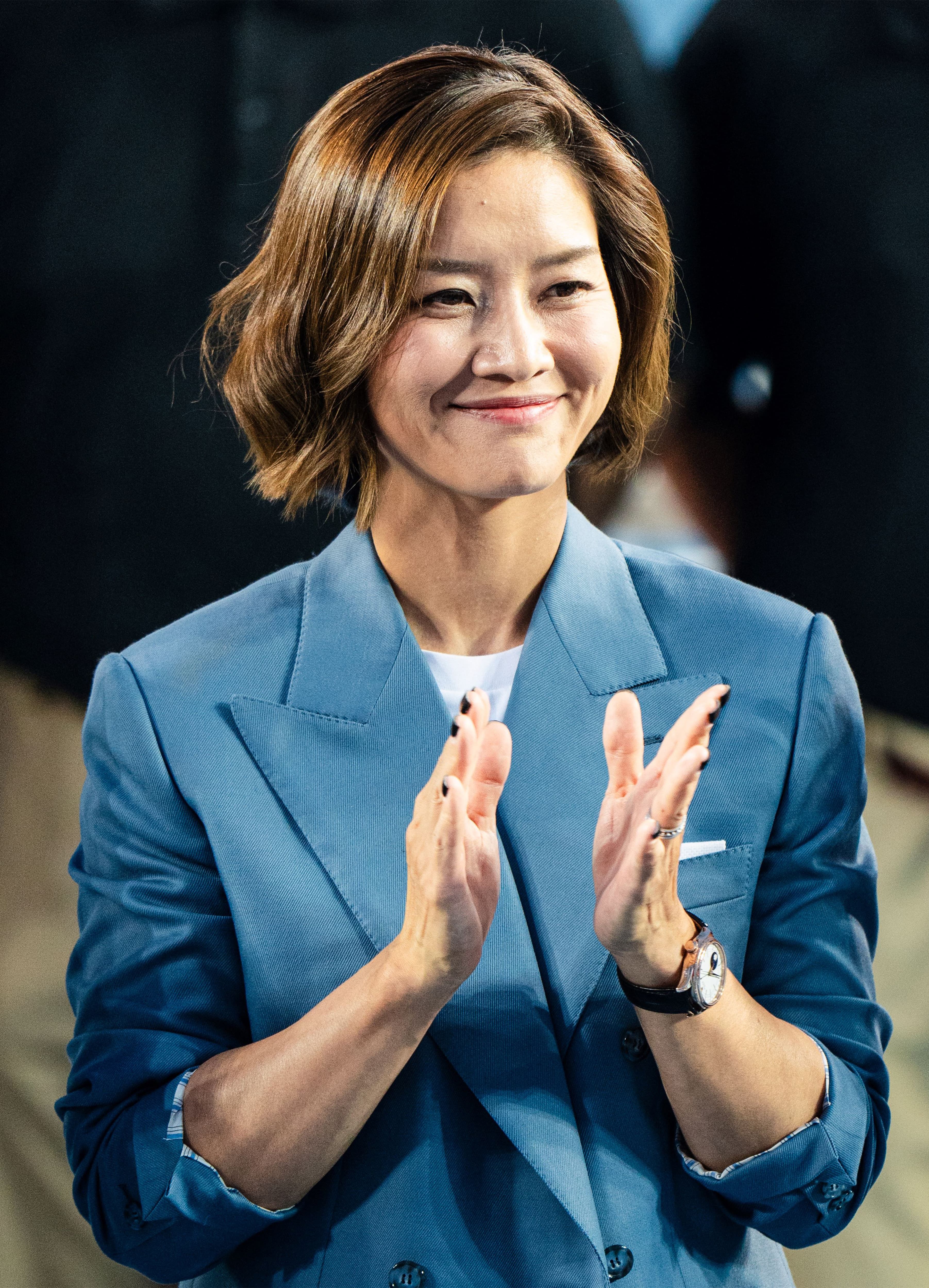 Li Na wearing a Brioni blue blazer with a warm smile.