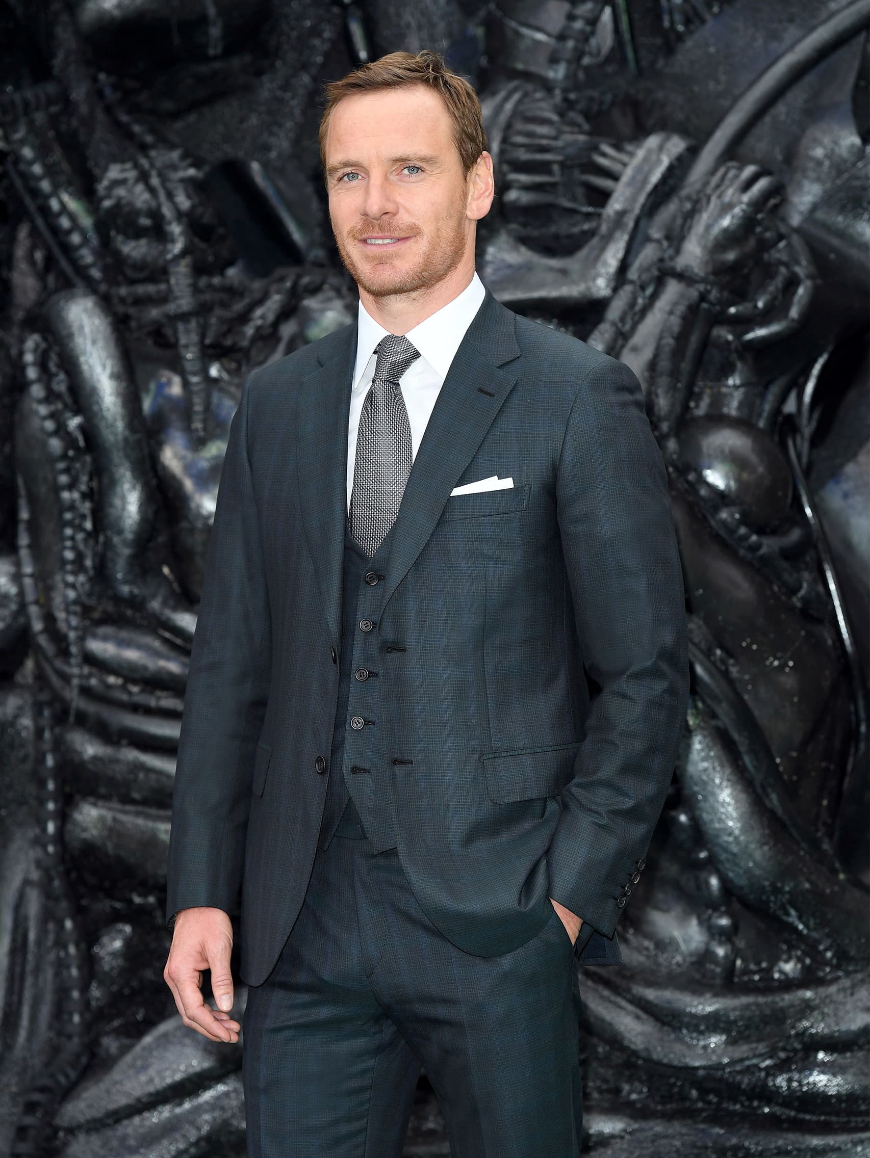 Michael Fassbender wearing a Brioni bespoke dark green three-piece suit