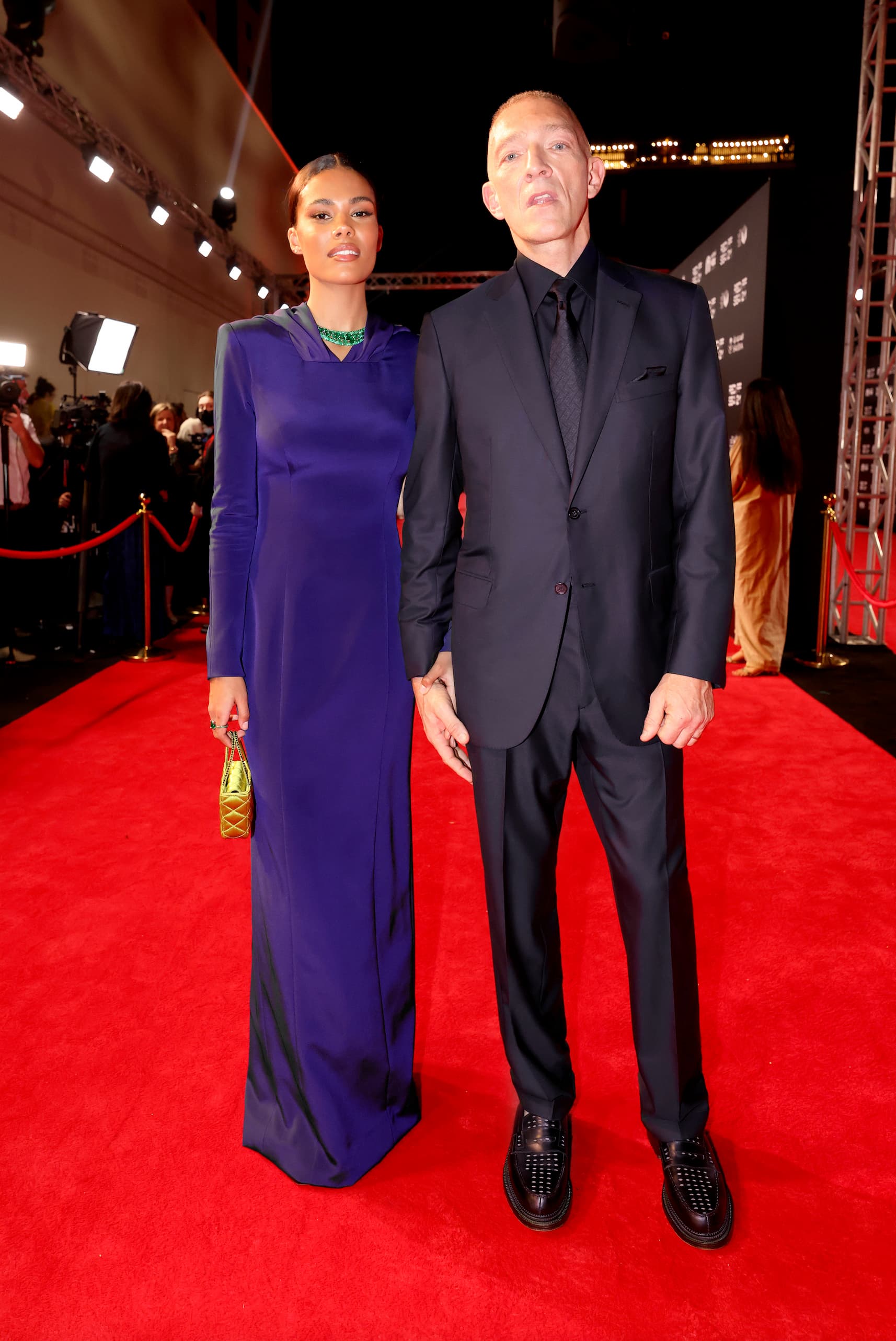 Vincent Cassel, pictured with Tina Kunakey, wearing a Brioni blue suit